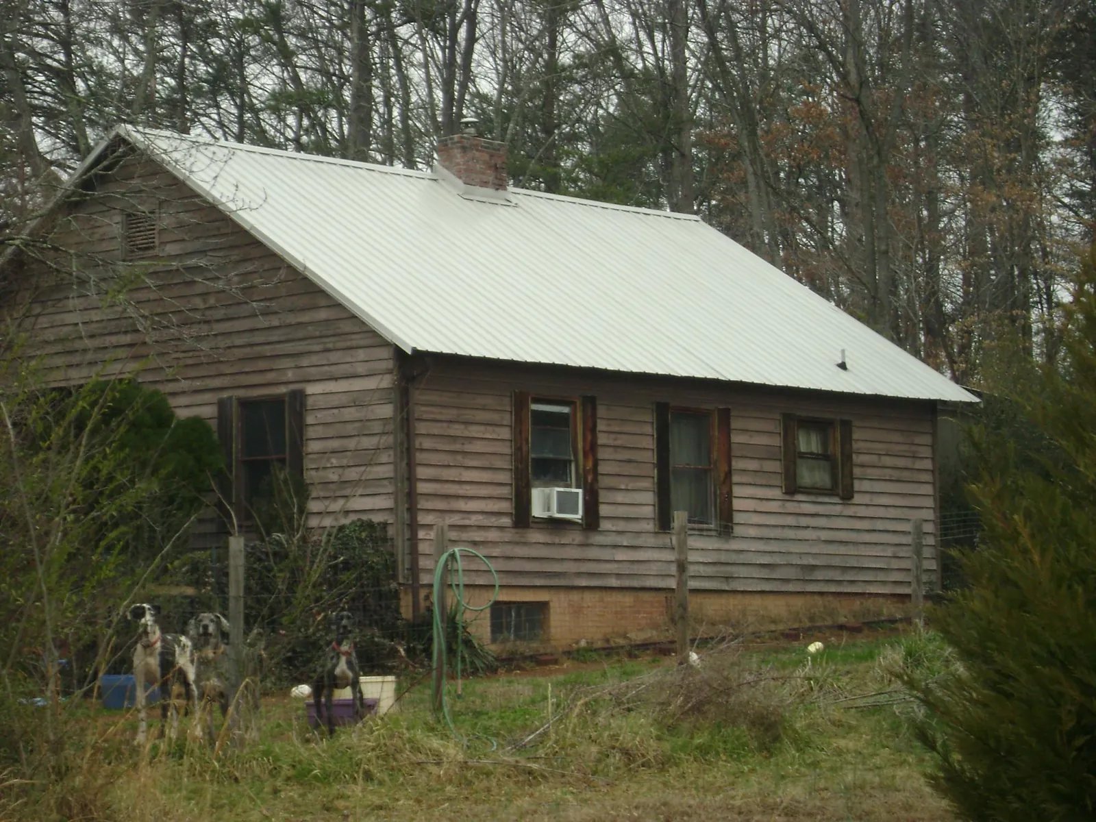 White metal roof on an old wood sided farmhouse, from a Metal Roof Installation job in Wadsworth